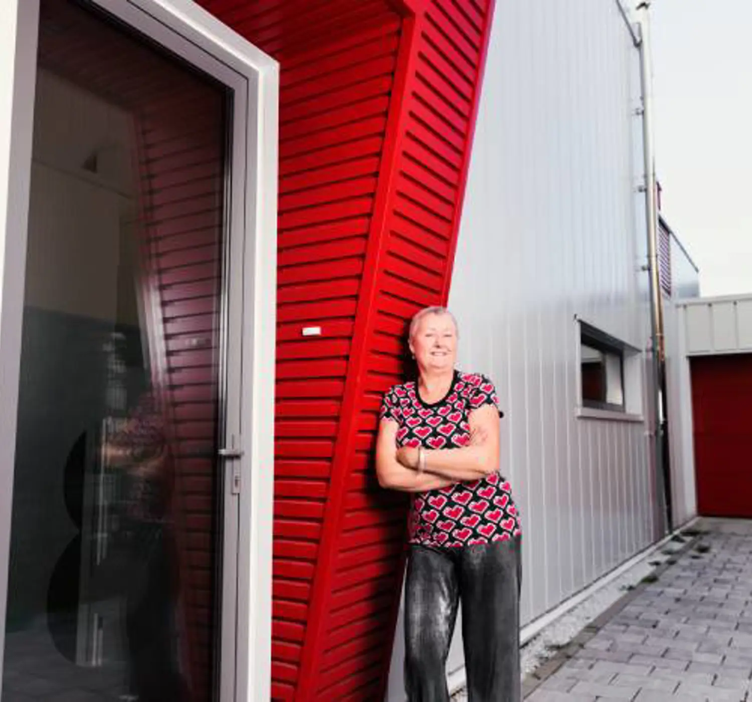 Vrouw bij eigen gebouwde huis van zeecontainers